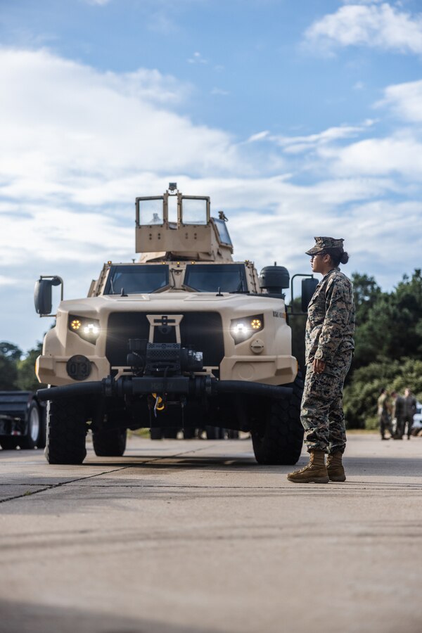 U.S. Marine Corps Pfc. Lucenise Lopezmontes, a motor vehicle operator with Combat Logistics Battalion 22, Combat Logistics Regiment 2, 2nd Marine Logistics Group, ground guides a vehicle during Defense Support of Civil Authorities mission rehearsals in Norfolk, Virginia, July 24, 2024. Marines and Sailors with the II Marine Expeditionary Force (II MEF) Maritime DSCA Task Force conducted a full mission rehearsal in order to practice deploying as a team in support of civil authorities. This rehearsal was designed by II MEF and United States Fleet Forces Command to integrate and increase amphibious capabilities on the East Coast for potential humanitarian relief and disaster assistance mission during this hurricane season. (U.S. Marine Corps photo by Cpl. Meshaq Hylton)