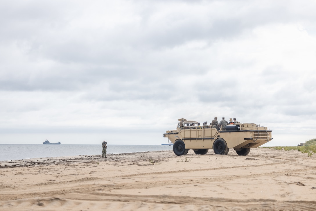 U.S. Marines with Combat Logistics Battalion 22, Combat Logistics Regiment 2, 2nd Marine Logistics Group, arrive on a beach during a beach landing for Defense Support of Civil Authorities mission rehearsals in Norfolk, Virginia, July 24, 2024. Marines and Sailors with the II Marine Expeditionary Force (II MEF) Maritime DSCA Task Force conducted a full mission rehearsal in order to practice deploying as a team in support of civil authorities. This rehearsal was designed by II MEF and United States Fleet Forces Command to integrate and increase amphibious capabilities on the East Coast for potential humanitarian relief and disaster assistance mission during this hurricane season. (U.S. Marine Corps photo by Cpl. Meshaq Hylton)