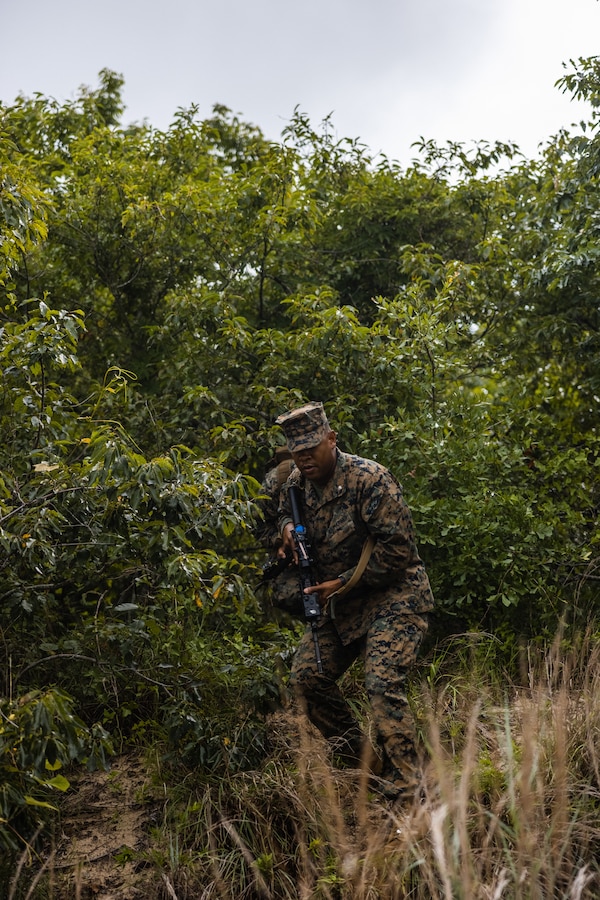 U.S. Marine Corps Lt. Col. Anthony Ansley, commanding officer of Combat Logistics Battalion 22, Combat Logistics Regiment 2, 2nd Marine Logistics Group, hikes to a retrograde point during Defense Support of Civil Authorities mission rehearsals in Norfolk, Virginia, July 24, 2024. Marines and Sailors with the II Marine Expeditionary Force (II MEF) Maritime DSCA Task Force conducted a full mission rehearsal in order to practice deploying as a team in support of civil authorities. This rehearsal was designed by II MEF and United States Fleet Forces Command to integrate and increase amphibious capabilities on the East Coast for potential humanitarian relief and disaster assistance mission during this hurricane season. (U.S. Marine Corps photo by Cpl. Meshaq Hylton)