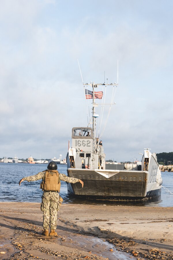 A landing craft utility lands at a beach during Defense Support of Civil Authorities mission rehearsals in Norfolk, Virginia, July 23, 2024. Marines and Sailors with the II Marine Expeditionary Force (II MEF) Maritime DSCA Task Force conducted a full mission rehearsal in order to practice deploying as a team in support of civil authorities. This rehearsal was designed by II MEF and United States Fleet Forces Command to integrate and increase amphibious capabilities on the East Coast for potential humanitarian relief and disaster assistance missions during hurricane season. (U.S. Marine Corps photo by Cpl. Meshaq Hylton)