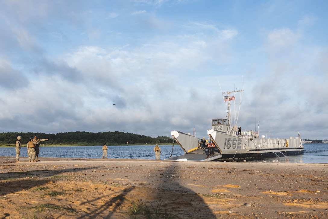 A landing craft utility lands at a beach during Defense Support of Civil Authorities mission rehearsals in Norfolk, Virginia, July 23, 2024. Marines and Sailors with the II Marine Expeditionary Force (II MEF) Maritime DSCA Task Force conducted a full mission rehearsal in order to practice deploying as a team in support of civil authorities. This rehearsal was designed by II MEF and United States Fleet Forces Command to integrate and increase amphibious capabilities on the East Coast for potential humanitarian relief and disaster assistance missions during hurricane season. (U.S. Marine Corps photo by Cpl. Meshaq Hylton)
