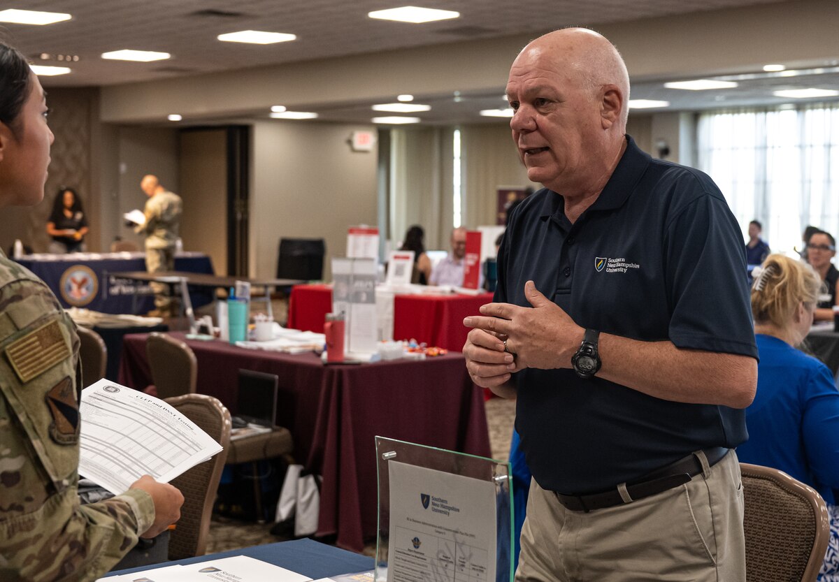 Chris McCollor, right, Southern New Hampshire University’s Senior Director of Military Partnerships, provides educational information to an Airman during an education fair at Wright-Patterson Air Force Base, Ohio, July 24, 2024.