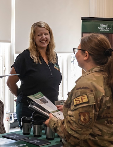 Kristina Healy, left, the Academic Services Director for Wright State University’s Raj Soin School of Business, interacts with an Airman during an education fair at Wright-Patterson Air Force Base, Ohio, July 24, 2024.