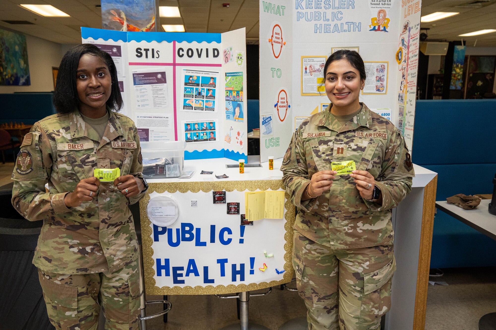 U.S. Air Force Airman 1st Class De'Nyzia Baker, 81st Medical Group public health technician, and Capt. Amber Sulahria, 81st Operational Medical Readiness Squadron audiologist, pose for a photo during the Student Health Fair on Keesler Air Force Base, Mississippi, July 19, 2024.