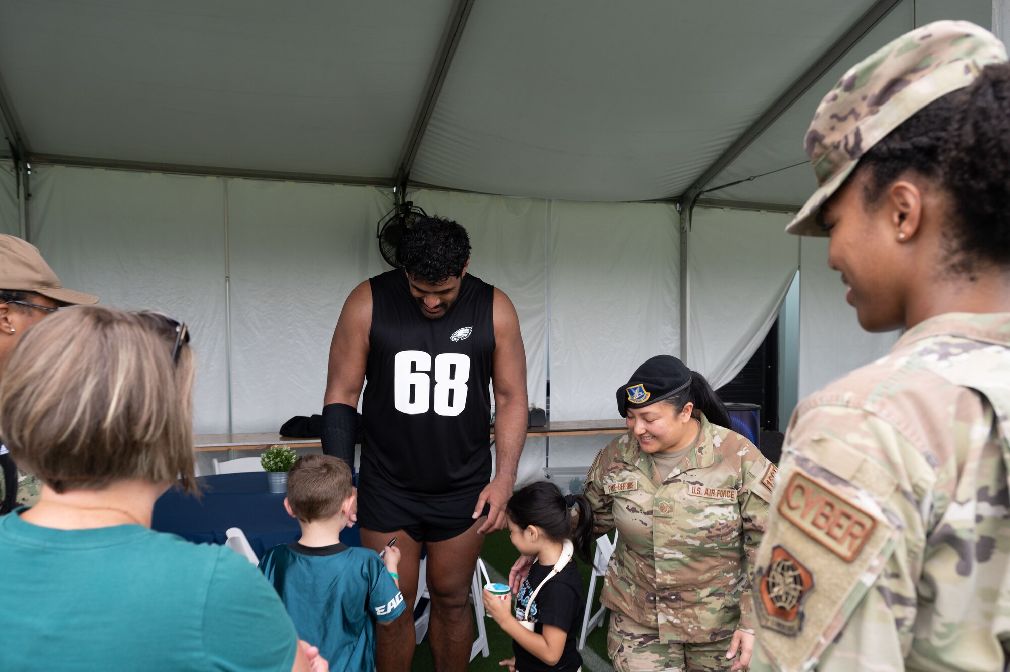 Jordan Mailata, Philadelphia Eagles offensive tackle greets U.S. Airmen and their families during The Eagles Training Camp at the Novacare Complex in Philadelphia, Pennsylvania, July 27, 2024. The event gave U.S. service members from all six branches of the military the opportunity to watch the Eagles’ practice before the start of the 2024-2025 football season. (U.S. Air Force photo by Senior Airman Dieondiere Jefferies)