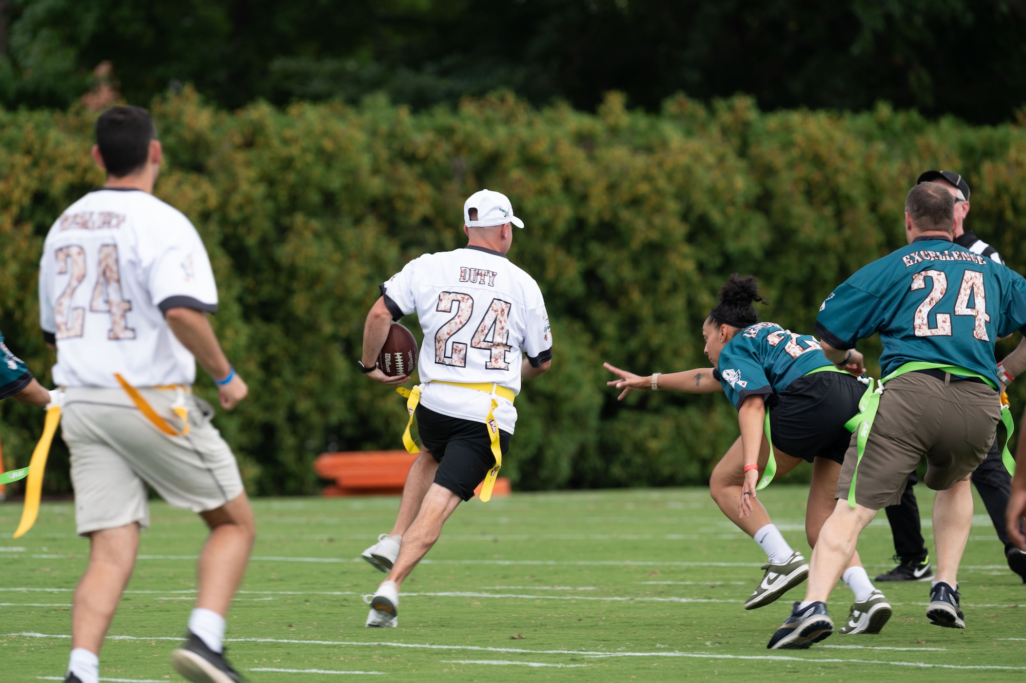 U.S. military members play flag football during The Eagles Training Camp event at the Novacare Complex in Philadelphia, Pennsylvania, July 27, 2024. The event gave U.S. service members from all six branches of the military the opportunity to watch the Eagles’ practice before the start of the 2024-2025 football season. (U.S. Air Force photo by Senior Airman Dieondiere Jefferies)