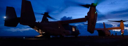 U.S. Marine Corps MV-22B Ospreys assigned to Marine Medium Tiltrotor Squadron 262 (Rein.), 31st Marine Expeditionary Unit, prepare for takeoff during night flight operations aboard the amphibious assault ship USS America (LHA 6) on July 25, 2024.