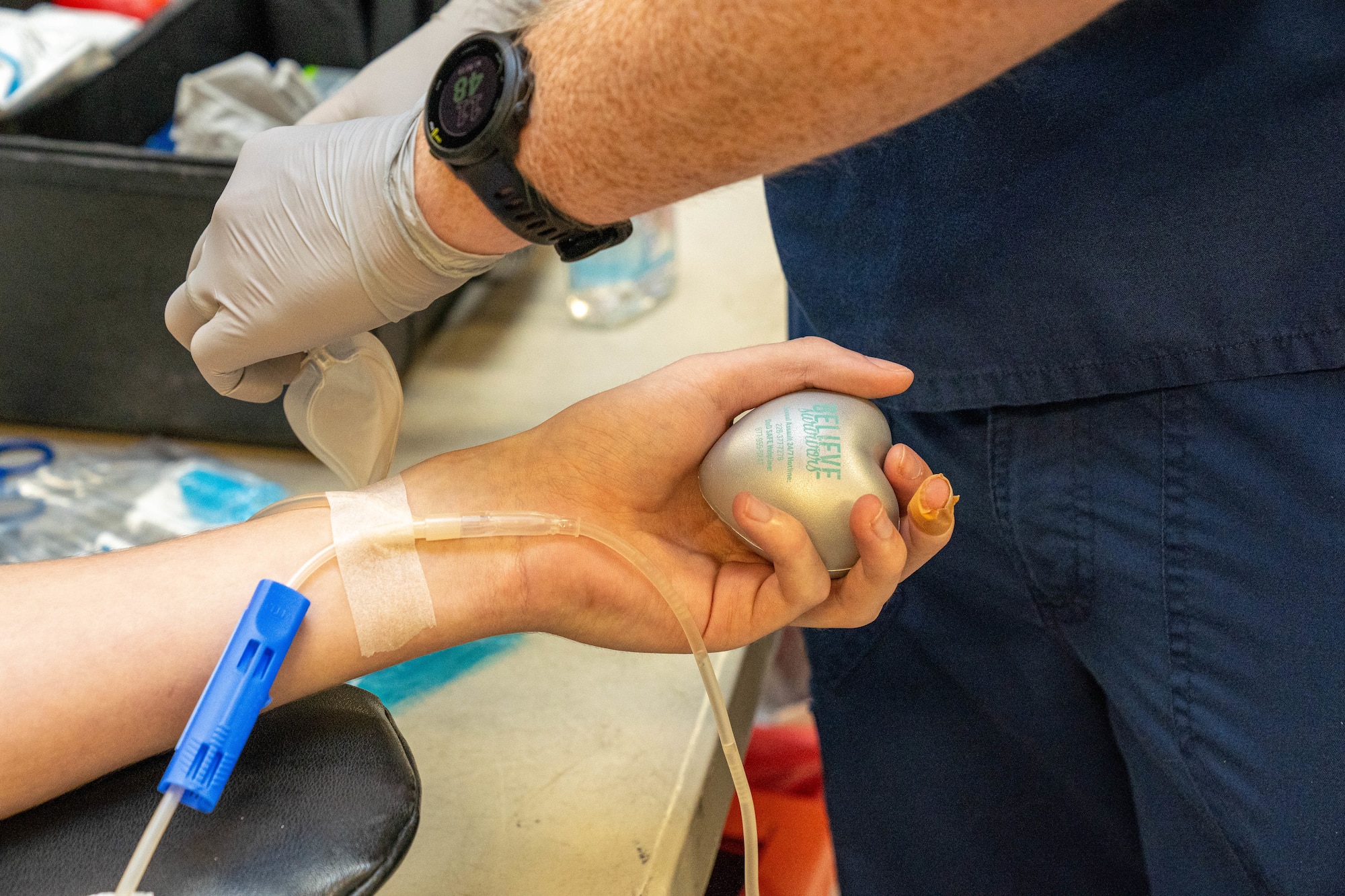 U.S. Air Force Airman 1st Class Tyler Pease, 81st Medical Group aerospace medical technician, squeezes a stress ball while getting his blood drawn at the Student Health Fair on Keesler Air Force Base, Mississippi, July 19, 2024.