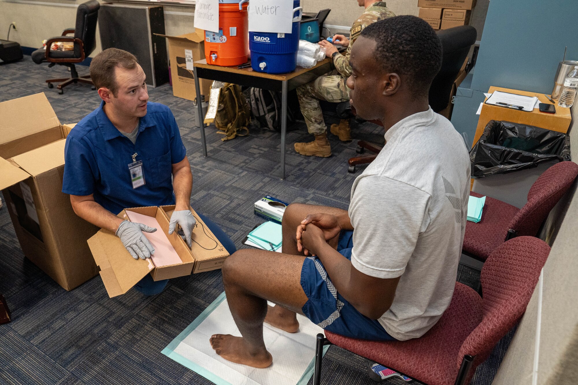 A member of the 81st Medical Group fits an 81st Training Group Airman with athletic shoes at the Student Health Fair on Keesler Air Force Base, Mississippi, July 19, 2024.