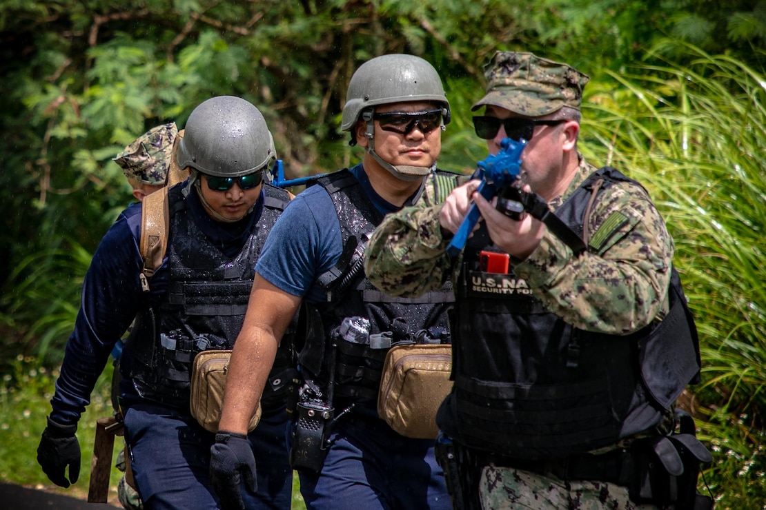 SANTA RITA, Guam (July 16, 2024)- Master-at-Arms 2nd Class Thomas Kilbourn (right) and Master-at-Arms Seaman Brinae Siegel, assigned to U.S. Naval Base Guam (NBG), escort medics assigned to Joint Region Marianas Fire and Emergency during an active shooter training, as a part of Citadel Pacific 2024, at the Sasa Valley Fuel Farm, July 16. Preparing military and security forces to respond during real-world incidents, the training involved the simulation of active shooters, injured bystanders, and hostages.