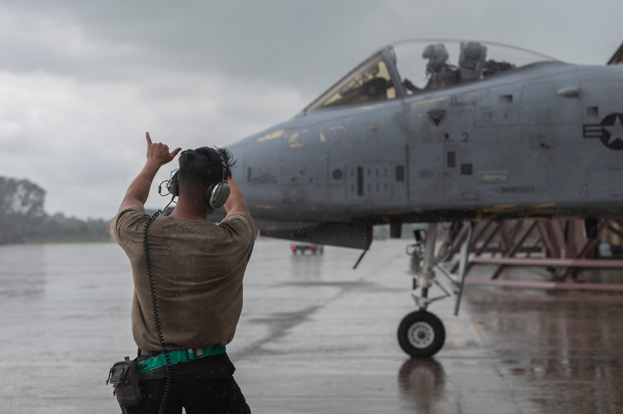 U.S. Air Force Senior Airman Nathan Cruz, 25th Fighter Generation Squadron crew chief, marshals an A-10 Thunderbolt II before takeoff at Osan Air Base, Republic of Korea, July 24, 2024. Crew chiefs maintain the reliability and capabilities of the A-10s by detecting malfunctions, fixing errors, and building overall competence, so pilots safely generate airpower across the Korean peninsula. (U.S. Air Force photo by Staff Sgt. Ashley N. Mikaio)