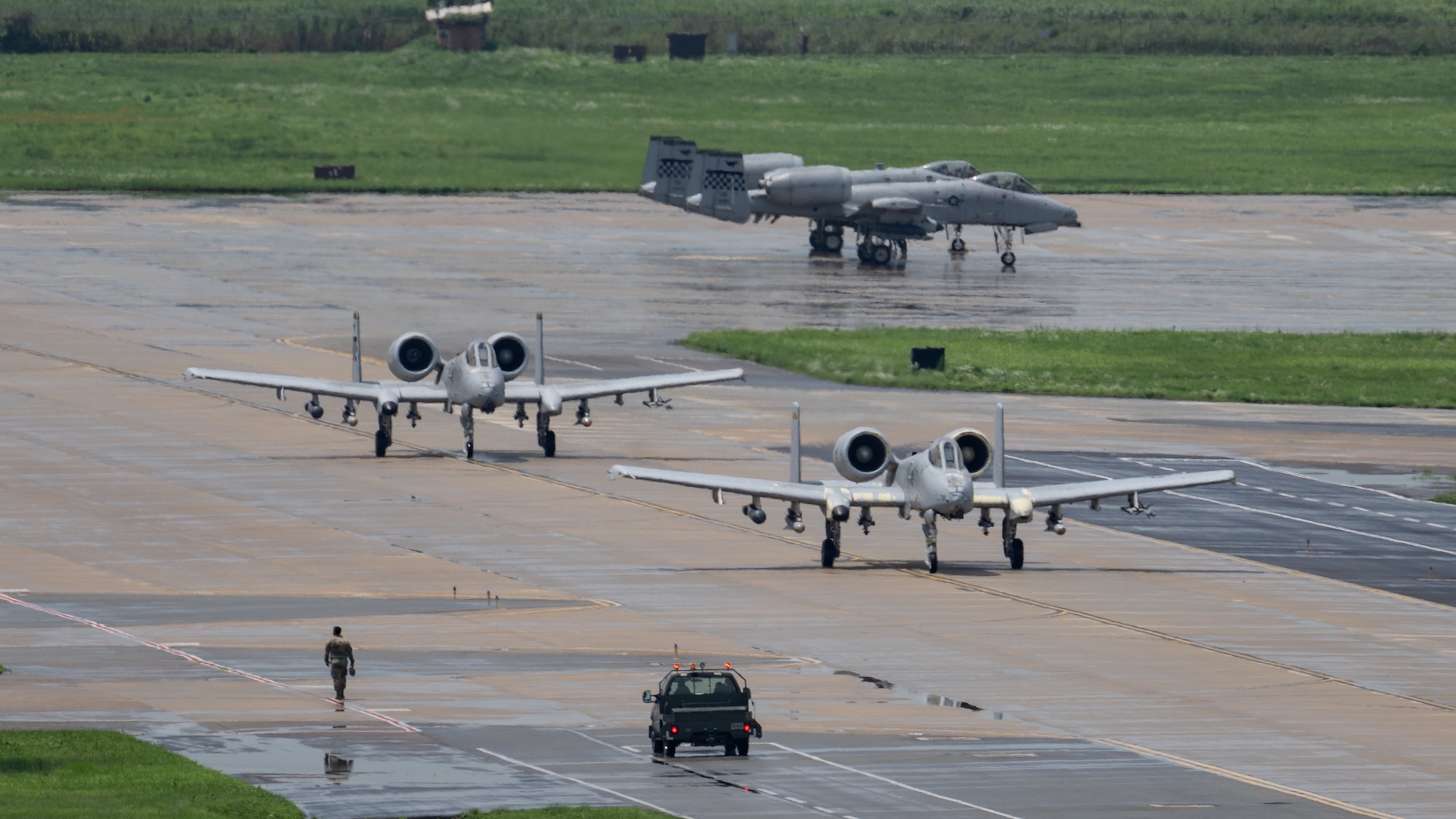 U.S. Air Force A-10 Thunderbolt IIs assigned to the 25th Fighter Squadron taxi down the runway at Osan Air Base, Republic of Korea, July 24, 2024. The 51st Fighter Wing operates two fighter squadrons comprised of the A-10 Thunderbolt II and F-16 Fighting Falcon; both working in tandem to defend our personnel and allies on the Korean peninsula. (U.S. Air Force photo by Capt. Kip Sumner)