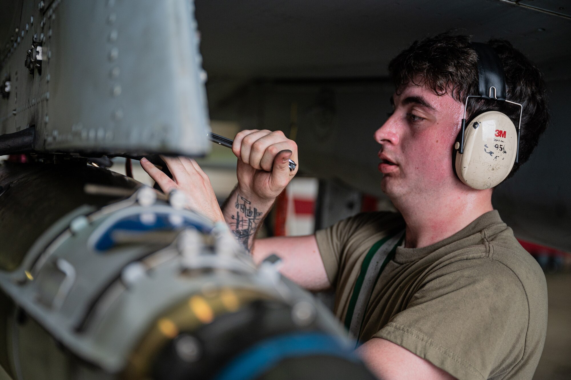 U.S. Air Force Airman 1st Class Brian Trask, 25th Fighter Generation Squadron weapons load crew member, participates during the 2nd Quarter Load Crew Competition at Osan Air Base, Republic of Korea, July 26, 2024. The competition is an opportunity to evaluate two load crew teams on their efficiency, teamwork and attention to detail while loading munitions onto an F-16 Fighting Falcon and an A-10 Thunderbolt II. (U.S. Air Force photo by Staff Sgt. Christopher Tam)