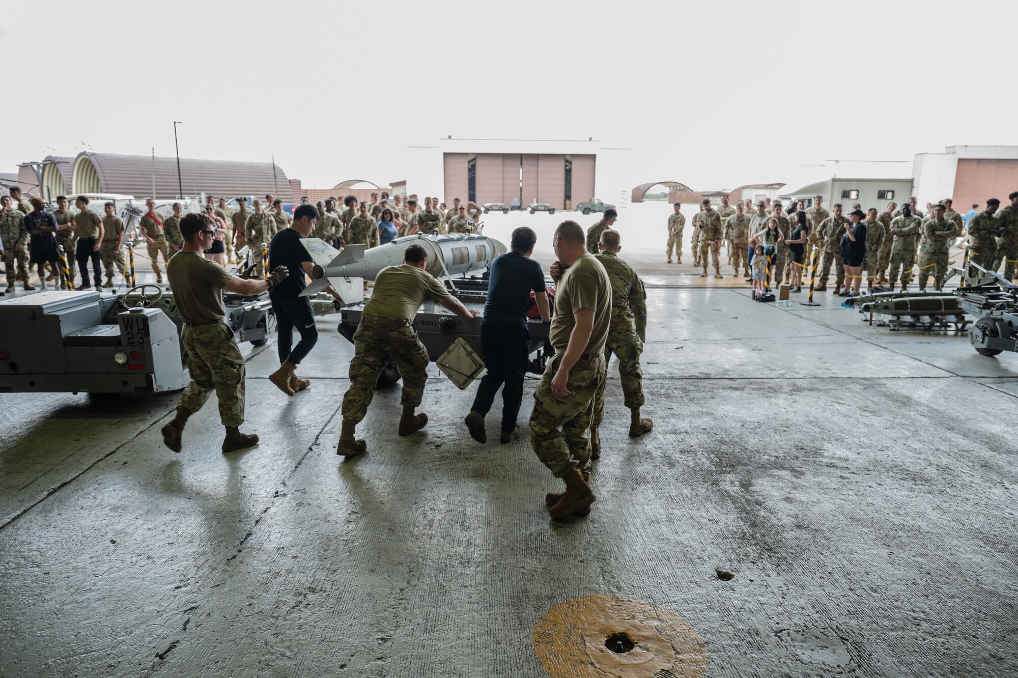 U.S. Air Force members assigned to the 25th Fighter Generation Squadron and 36th Fighter Generation Squadron participate in the 2nd Quarter Load Crew Competition at Osan Air Base, Republic of Korea, July 26, 2024. As part of the competition, teams are evaluated on how quickly and efficiently they can inspect and load munitions onto their respective aircraft. (U.S. Air Force photo by Staff Sgt. Christopher Tam)