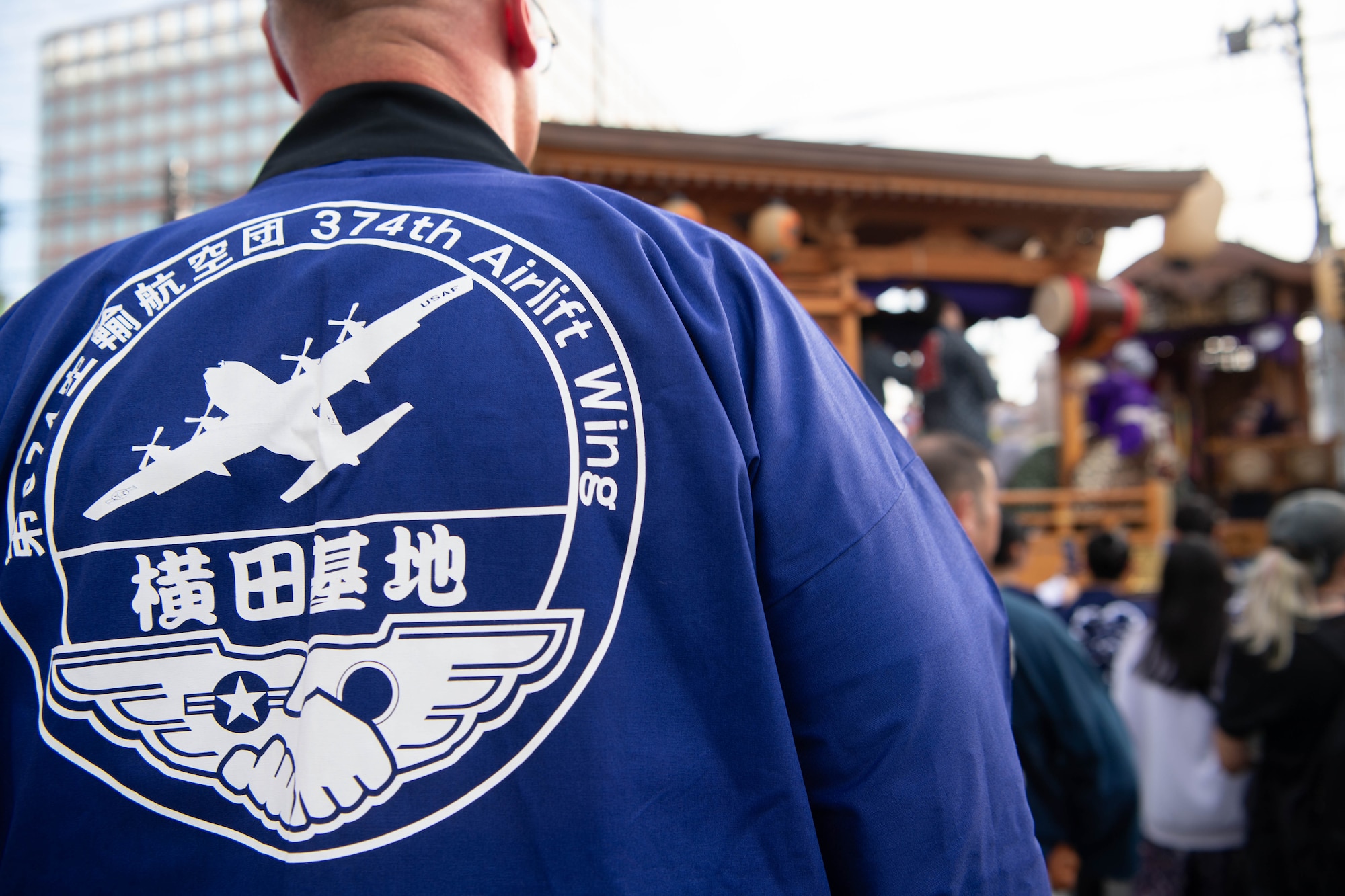 An Airman dons his coat.