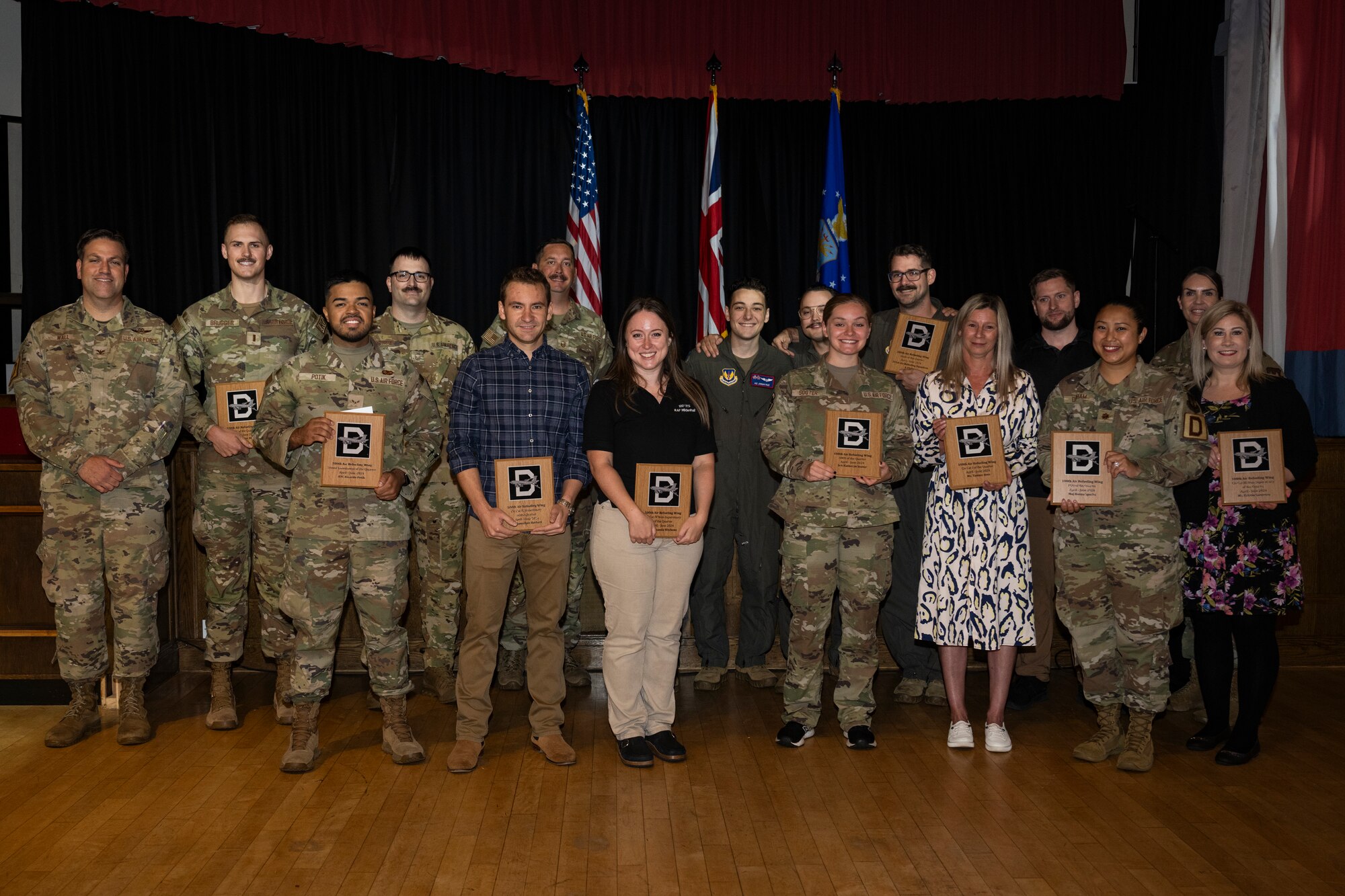 U.S. Airmen and civilians with the 100th Air Refueling Wing pose for a group photo during a quarterly awards ceremony at Royal Air Force Mildenhall, England, July 26, 2024.