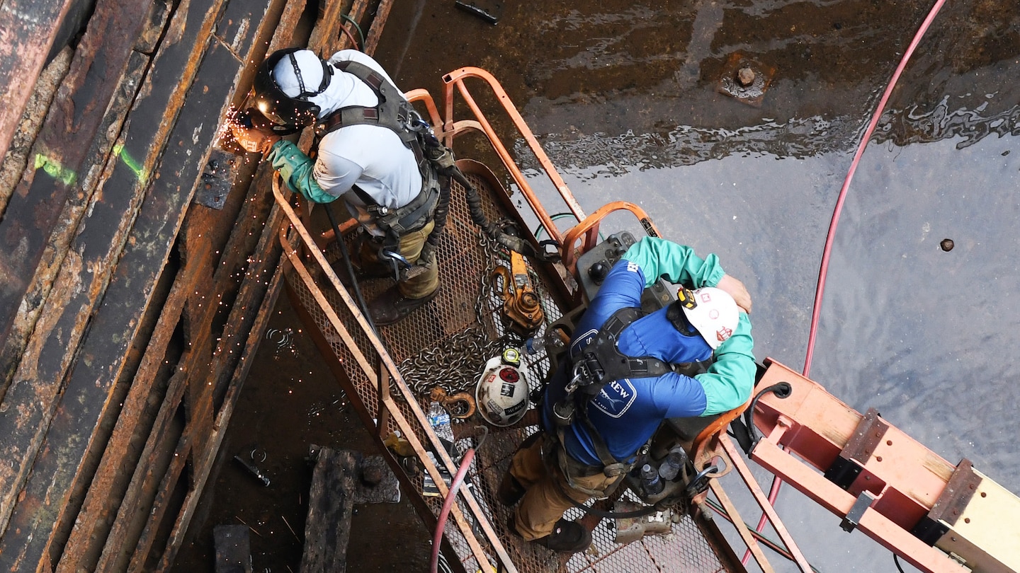 A welder from the U.S. Army Corps of Engineers Regional Rivers Repair Fleet welds one of the more than 40 cracks identified in the Old Hickory Lock chamber gates in Hendersonville, Tennessee, July 19, 2024. The water from the lock chamber is pumped out and repairs are made over the course of three weeks to ensure continued operability of the nearly 70-year-old lock. (USACE Photo by Mike Davis)
