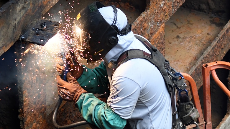 A welder from the U.S. Army Corps of Engineers Regional Rivers Repair Fleet welds one of the more than 40 cracks identified in the Old Hickory Lock chamber gates in Hendersonville, Tennessee, July 19, 2024. The water from the lock chamber is pumped out and repairs are made over the course of three weeks to ensure continued operability of the nearly 70-year-old lock. (USACE Photo by Mike Davis)