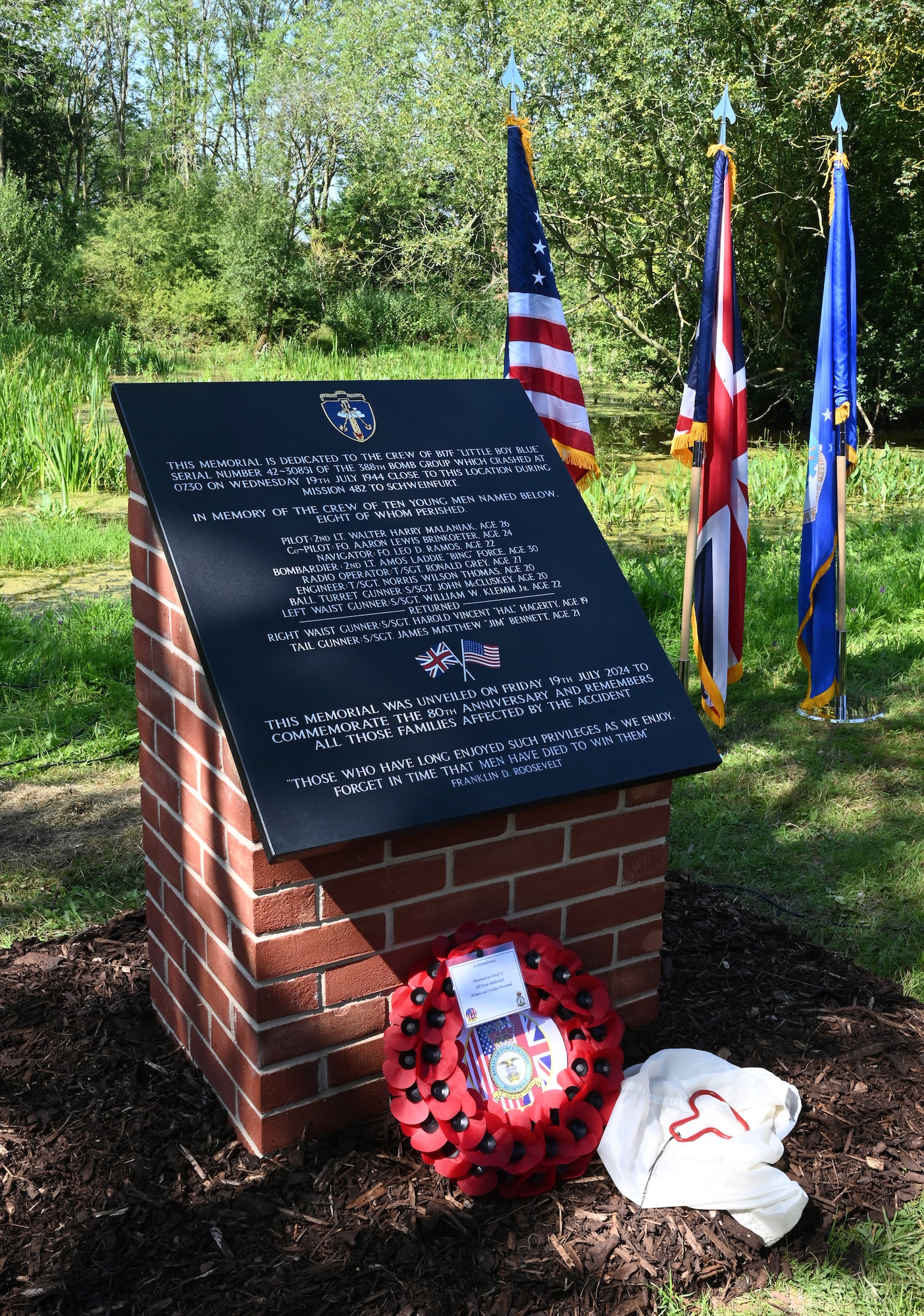 A memorial dedicated to the crew of a B-17 Flying Fortress, “Little Boy Blue” is on display after being unveiled at a ceremony near Bury St. Edmunds, Suffolk, July 19, 2024. The fuselage of the B-17 ripped in half after a collision with another aircraft on the way to a mission to bomb a ball-bearing factory in Schweinfurt, Germany. Right-waist gunner Staff Sgt. (S/Sgt) Harold “Hal” Hagerty was one of just two survivors, after he grabbed his parachute and jumped from the plane. A piece of the parachute which saved his life – along with the ripcord handle – was displayed next to the memorial, brought by Hal’s son, Patrick, to the ceremony. The accident was at 15,000 feet and his parachute opened at 2,500 feet. (U.S. Air Force photo by Karen Abeyasekere)
