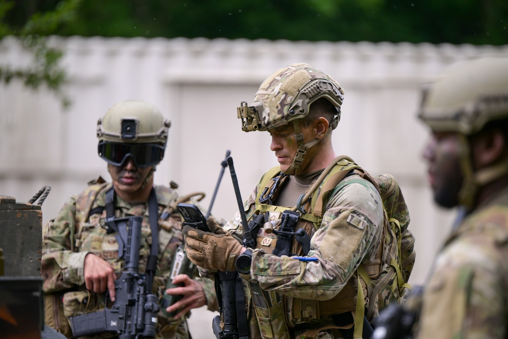 Integrated Defense Leadership Course student Master Sgt. Kevin Walter, a member of the 349th Security Forces Squadron from Travis Air Force Base, California, takes a photo of staged munitions during an area security operations exercise at Camp James A. Garfield Joint Military Training Center, Ohio, July 25, 2024.