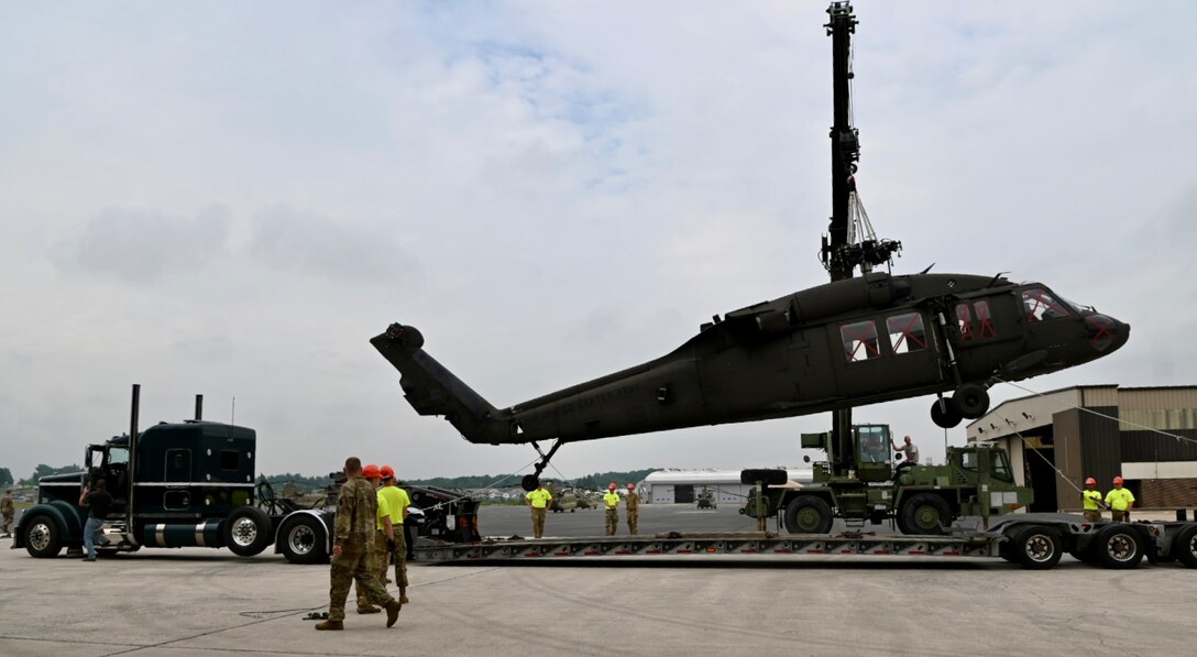 U.S. Soldiers with the Pennsylvania National Guard move a UH-60 Black Hawk helicopter onto a flatbed truck at Fort Indiantown Gap, Pennsylvania, July 24, 2024.