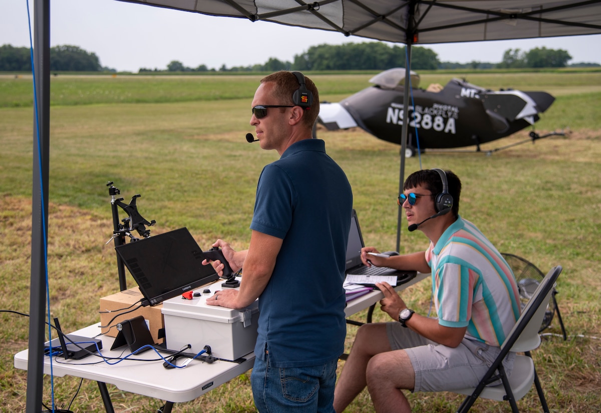 Joshua Bohun, left, Sinclair College associate director for advanced air mobility training and the remote pilot in command, and Cameron Smock, Sinclair College unmanned aircraft systems program technician and ground control station operator, conduct a Pivotal BlackFly electric vertical take-off and landing aircraft test flight at Springfield-Beckley Airport, Ohio, July 12, 2024.