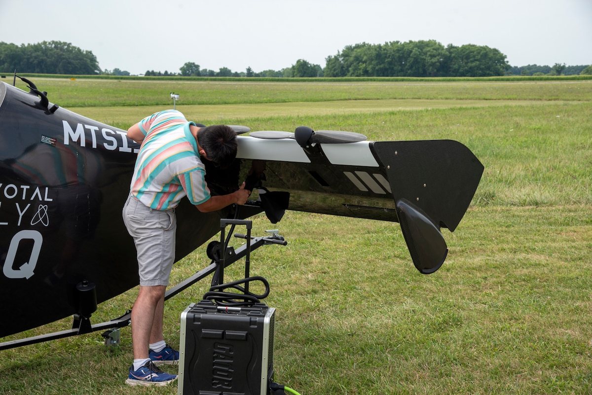 Cameron Smock, Sinclair College unmanned aircraft systems program technician, plugs-in the Pivotal BlackFly electric vertical take-off and landing aircraft at Springfield-Beckley Airport, Ohio, July 12, 2024.