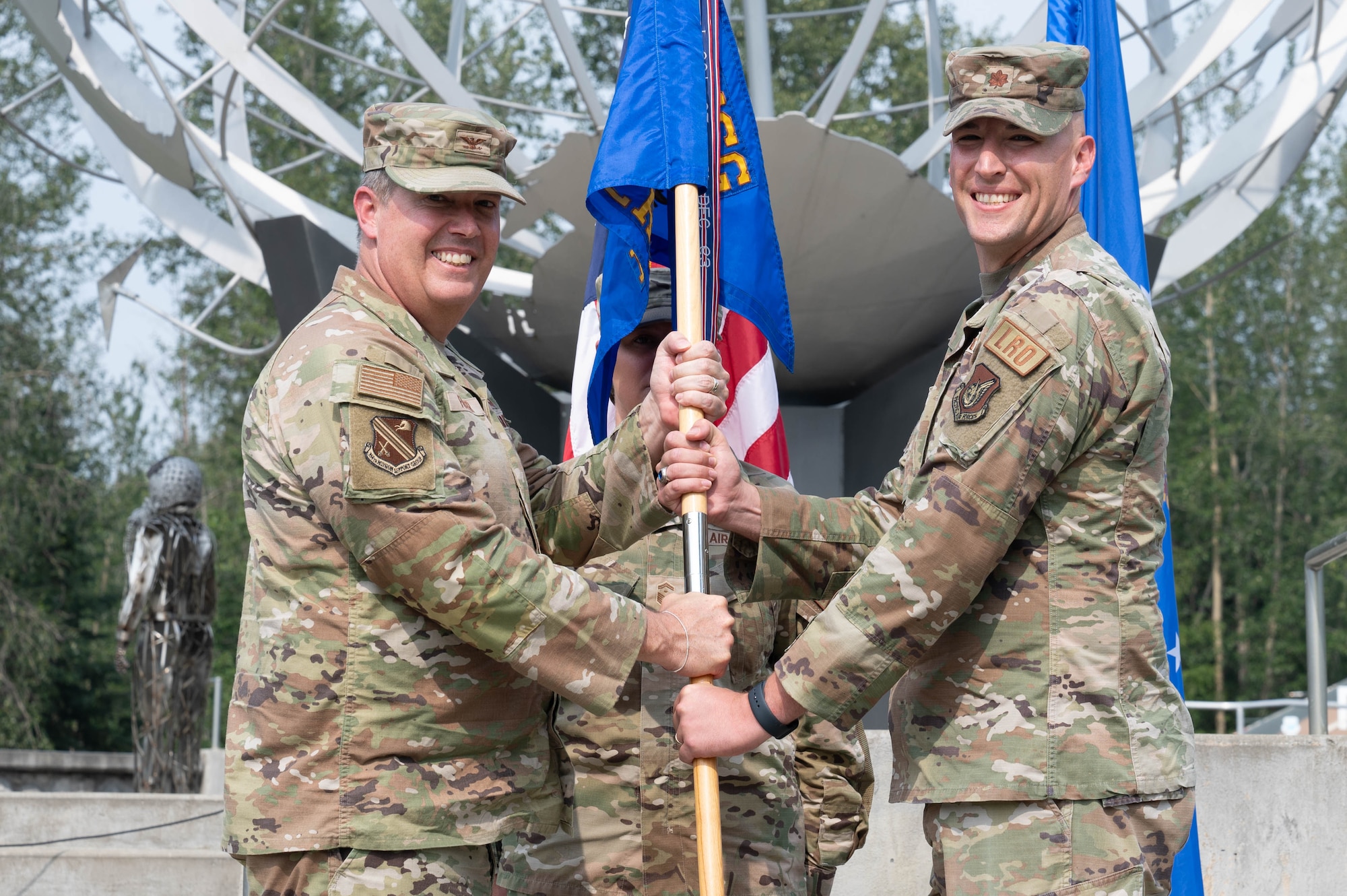 U.S. Air Force Col. Timothy Foster (left), 354th Mission Support Group commander, presents the guidon to Maj. Peter Daigle, 354th Logistics Readiness Squadron incoming commander, at the 354th LRS change of command ceremony at Eielson Air Force Base, Alaska, July 24, 2024.