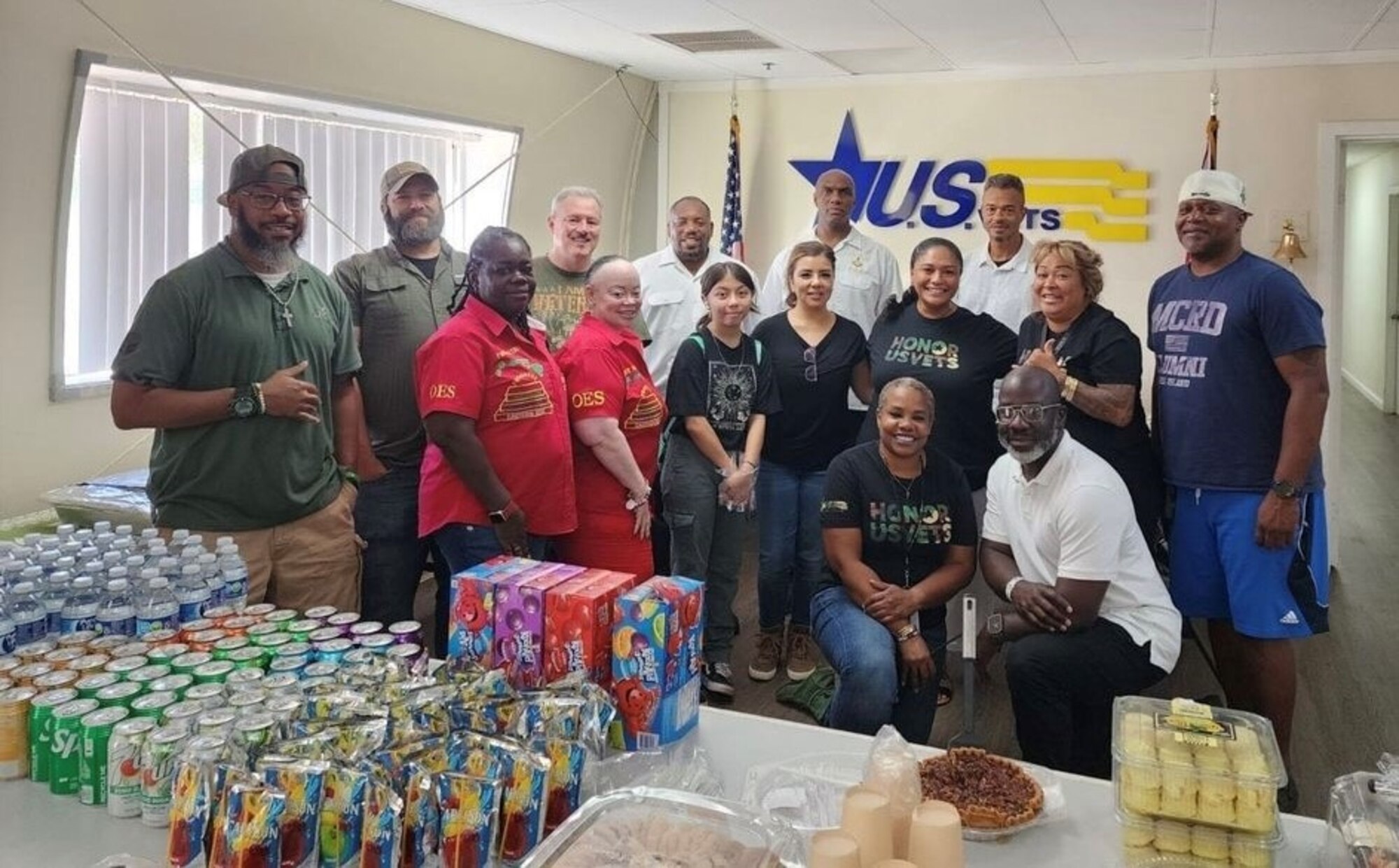 Cory Favors poses for a photo with fellow 21 SOPS members and volunteers.