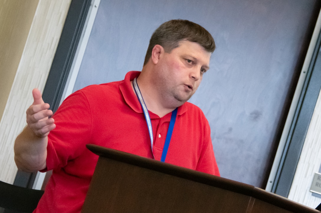 A man speaks behind a podium