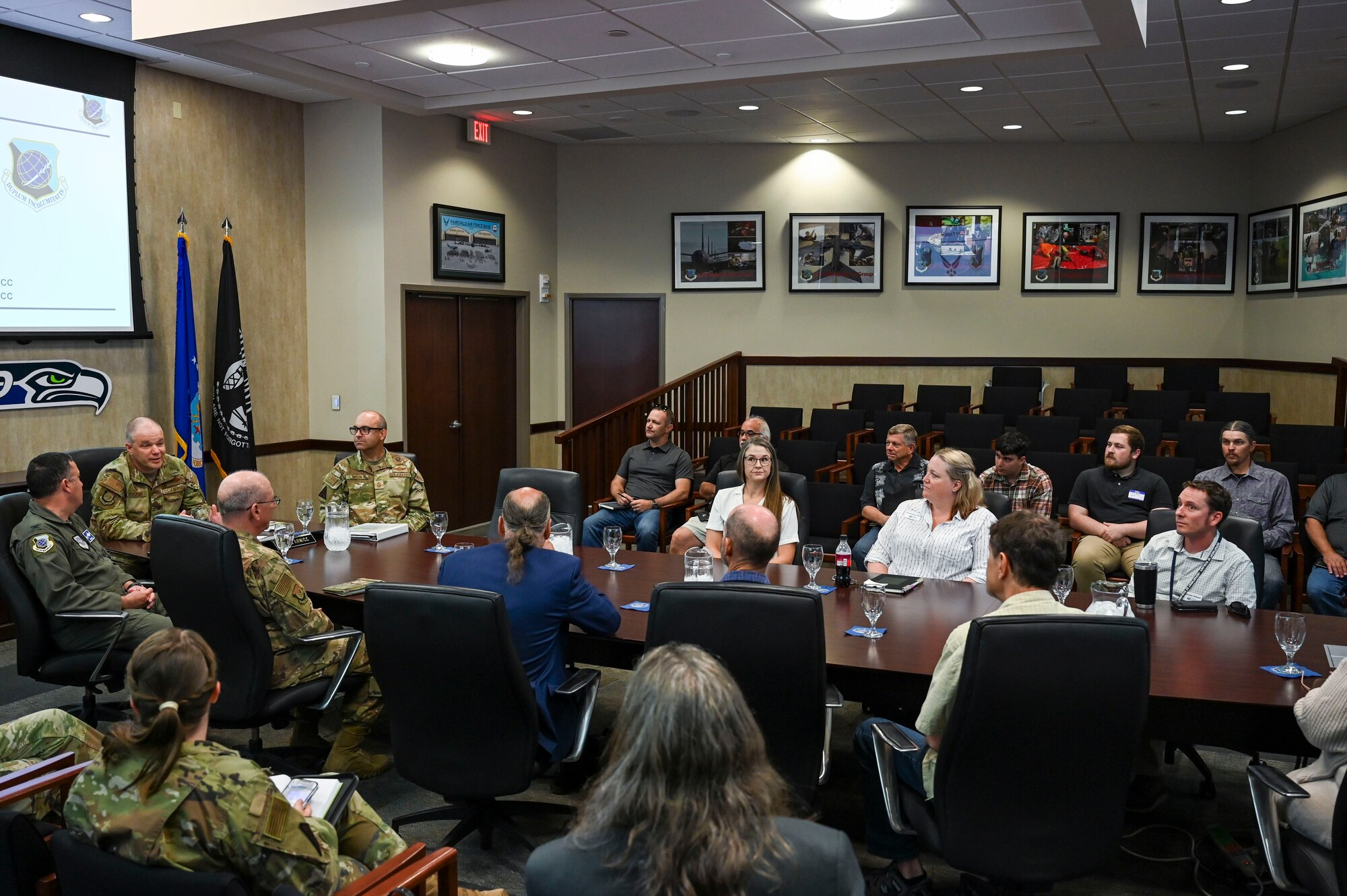 A group of people sit in a conference room.
