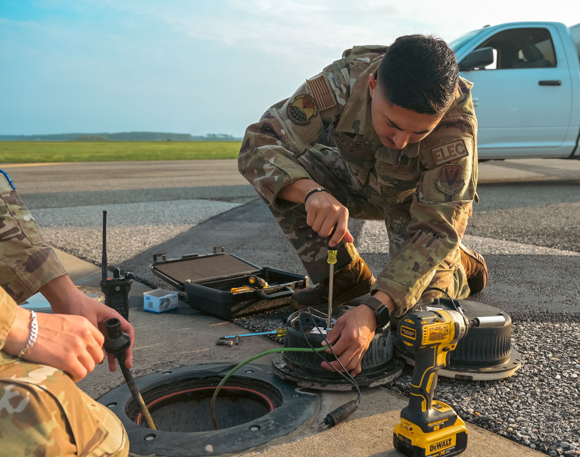 Airman fixing light on the flight line.