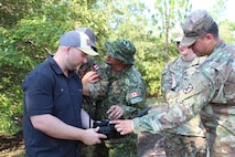 Soldiers discuss cyber capabilities on new equipment being tested at Cyber Quest 24, an annual data-centric exercise that provides capability development and acquisition communities a unique, realistic, operationally based environment to improve critical capability needs of Cyber, Electronic Warfare, Intelligence and Signal operational forces.