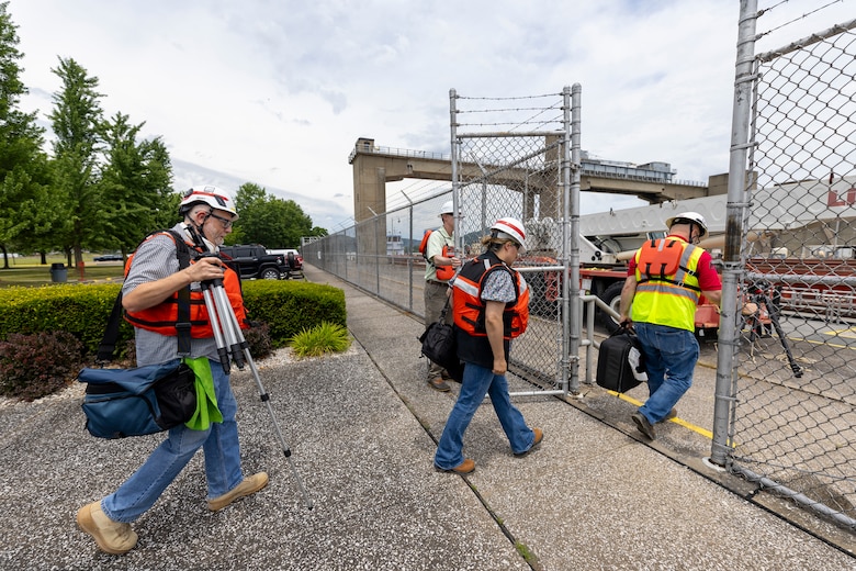 Michael Maddox, Emily Helton and Lee Roberts, U.S. Army Corps of Engineers public affairs specialists from the Louisville, Chicago and Nashville and districts, respectively, carry video equipment during a regional visual storytelling workshop at the Hannibal Locks and Dam in Hannibal, Ohio, June 25, 2024.