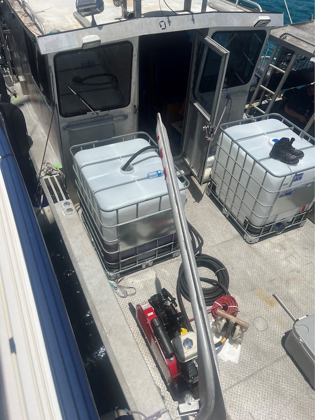 Photo showing the vessel carrying the totes receiving the fuel from the grounded sailing vessel catamaran Obsession being recovered by Resolve Marine and Clean Harbors personnel July 30, 2024, just off Flamenco Beach in Culebra, Puerto Rico.  The Coast Guard established and Incident Command with local and federal interagency partners, July 26, 2024, to oversee the removal of an estimated 800 to 1,500 gallons of diesel from the vessel as well as the engine oil and any potential hazardous materials onboard. (Courtesy photo)