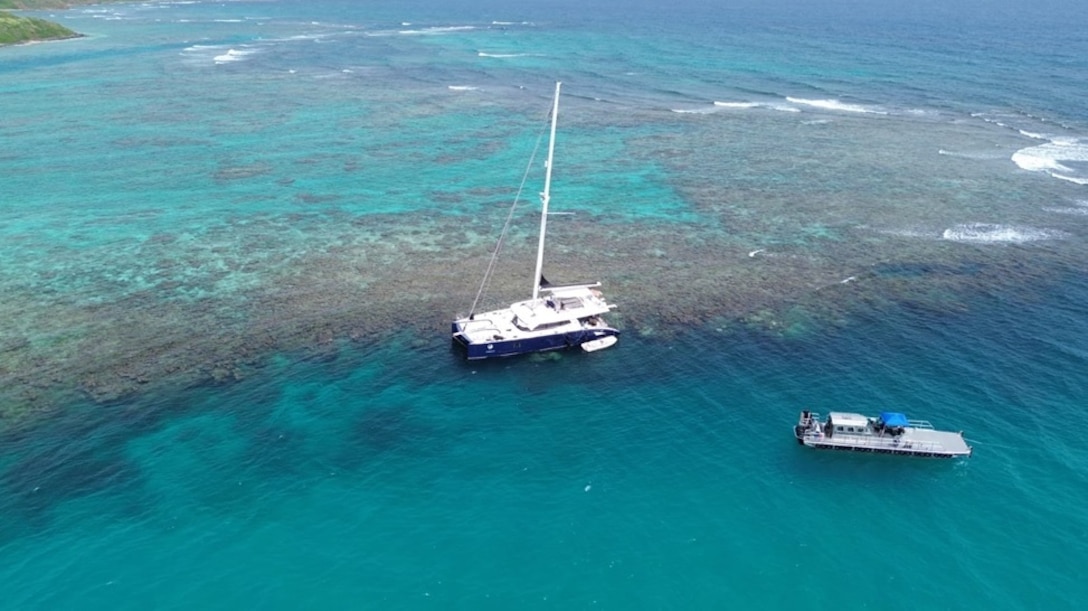 Photo showing the 72-foot sailing vessel catamaran Obsession hard aground on a reef just off Flamenco Beach in Culebra, Puerto Rico, July 25, 2024.  The Coast Guard established and Incident Command with local and federal interagency partners, July 26, 2024, to oversee the removal of an estimated 800 to 1,500 gallons of diesel from the vessel as well as the engine oil and any potential hazardous materials onboard. (Courtesy photo)