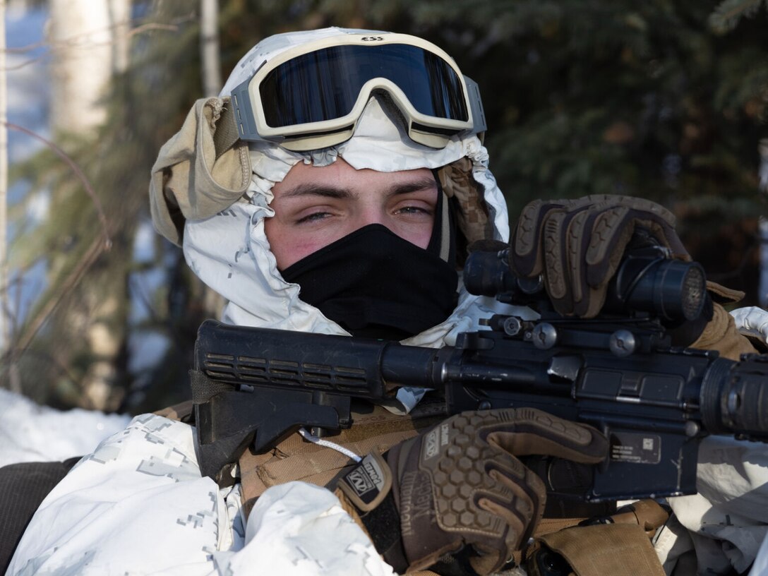 A service member wears cold weather gear.