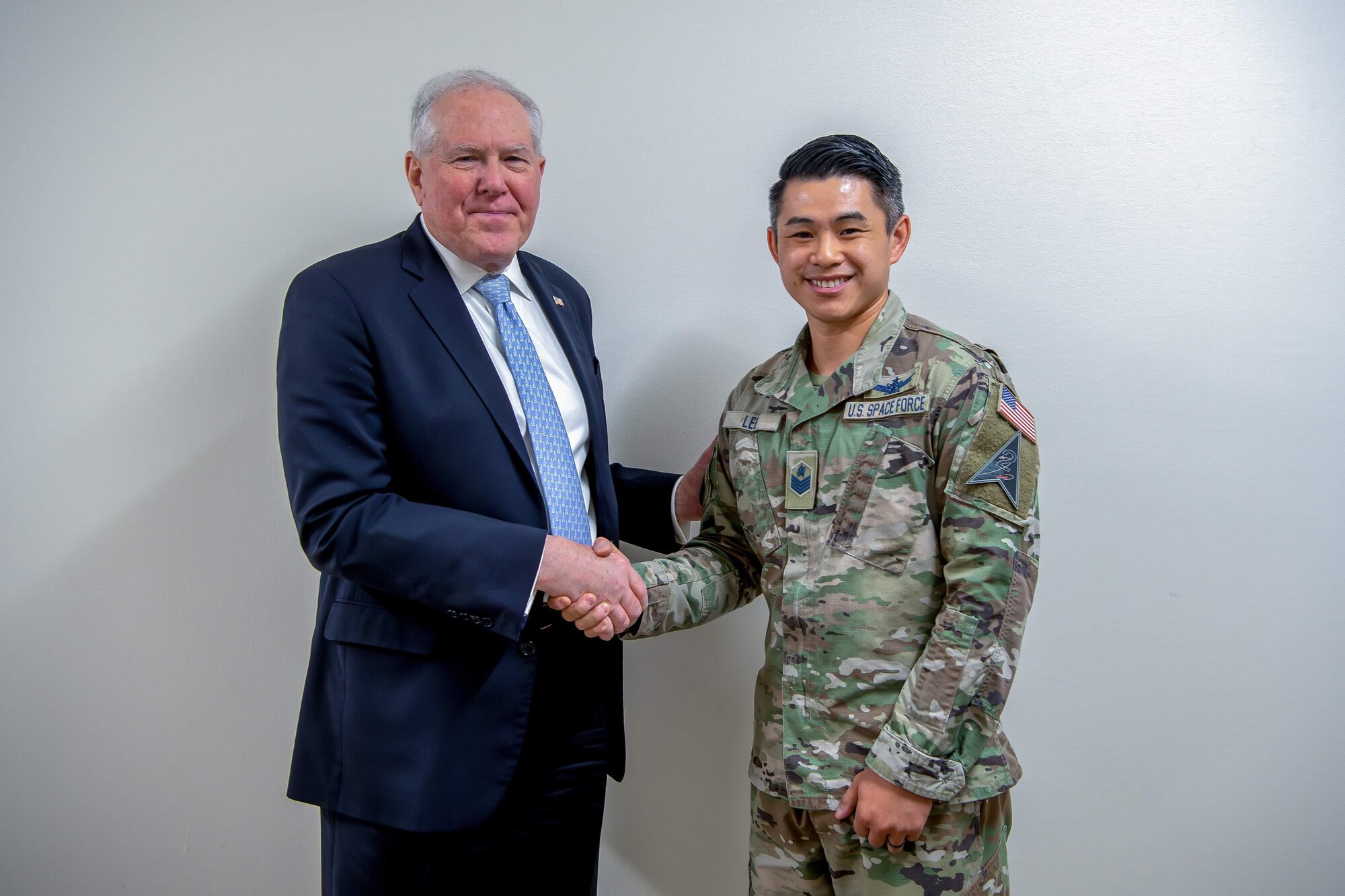 A service member shakes hands with Secretary of the Air Force