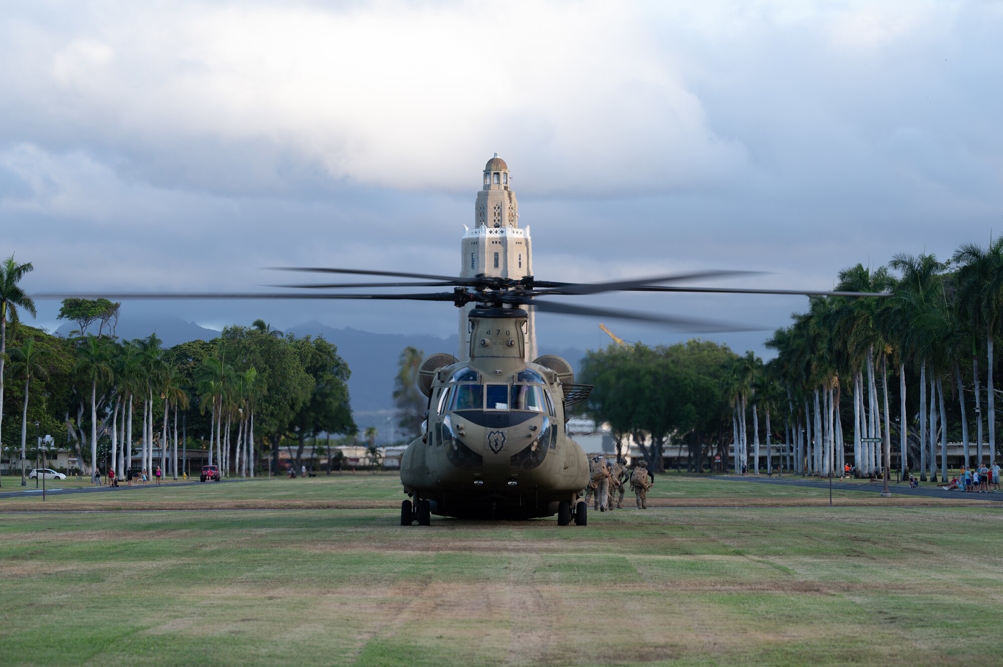 A chinook lands in a field.