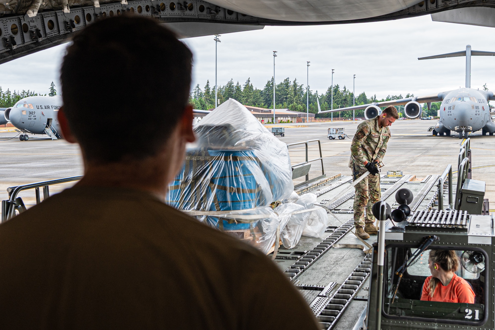 Members assigned to the 62d Airlift Wing load a C-17 Globemaster III at Joint Base Lewis-McChord, Washington, July 30, 2024. Air transportation specialists are given the responsibility of inspecting, documenting, packaging, loading and unloading cargo off of and onto aircraft. (U.S. Air Force photo by Airman 1st Class Benjamin Riddle)