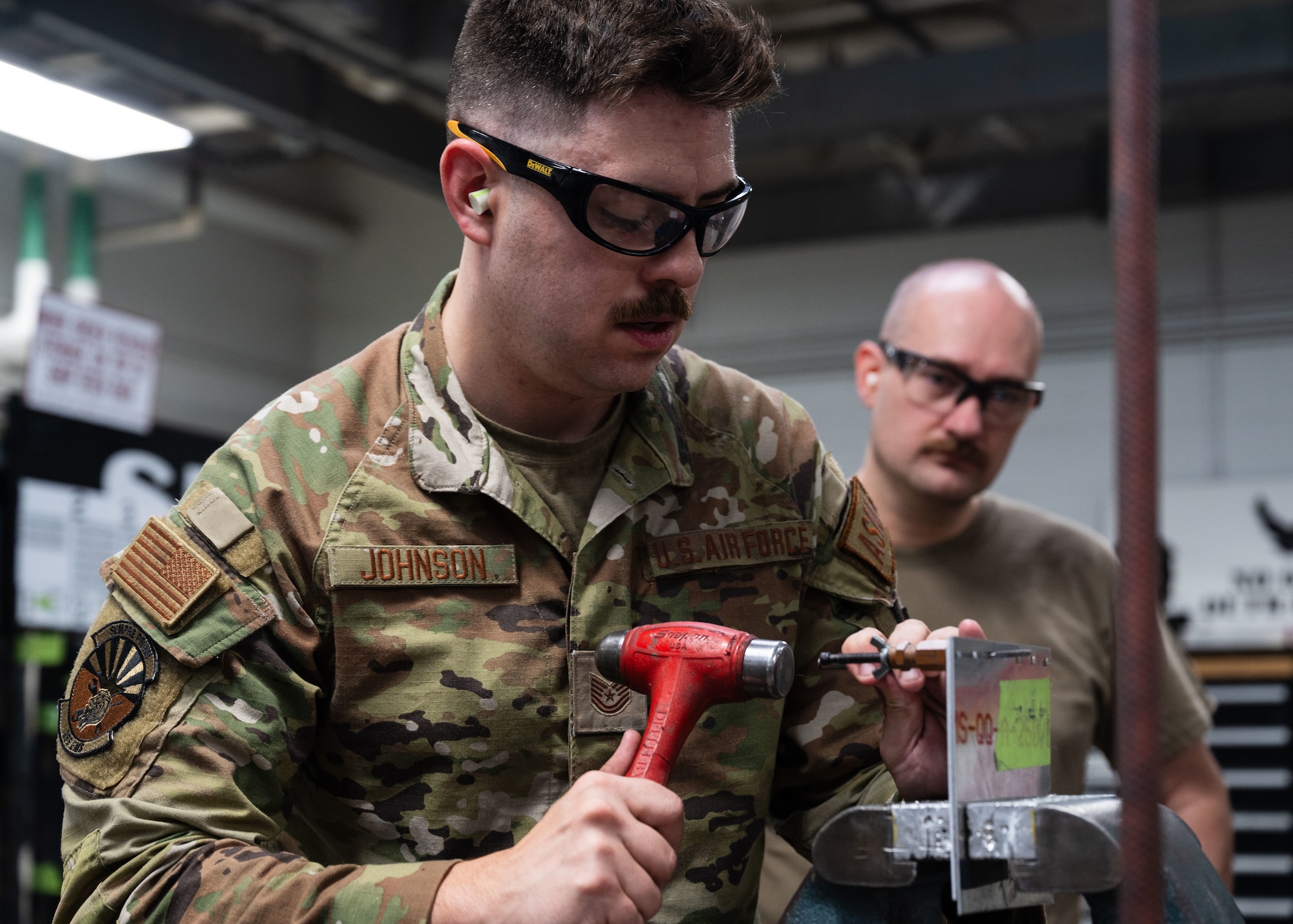 A U.S. Airman assigned to the 355th
Maintenance Group demonstrates how to
secure a drill bit during a Federal Aviation
Administration Airframe and Powerplant
certification course at Davis-Monthan Air
Force Base, Ariz., July 17, 2024. The course
was designed to teach students different
components of aircraft maintenance. (U.S. Air
Force photo by Airman 1st Class Jasmyne
Bridgers-Matos)