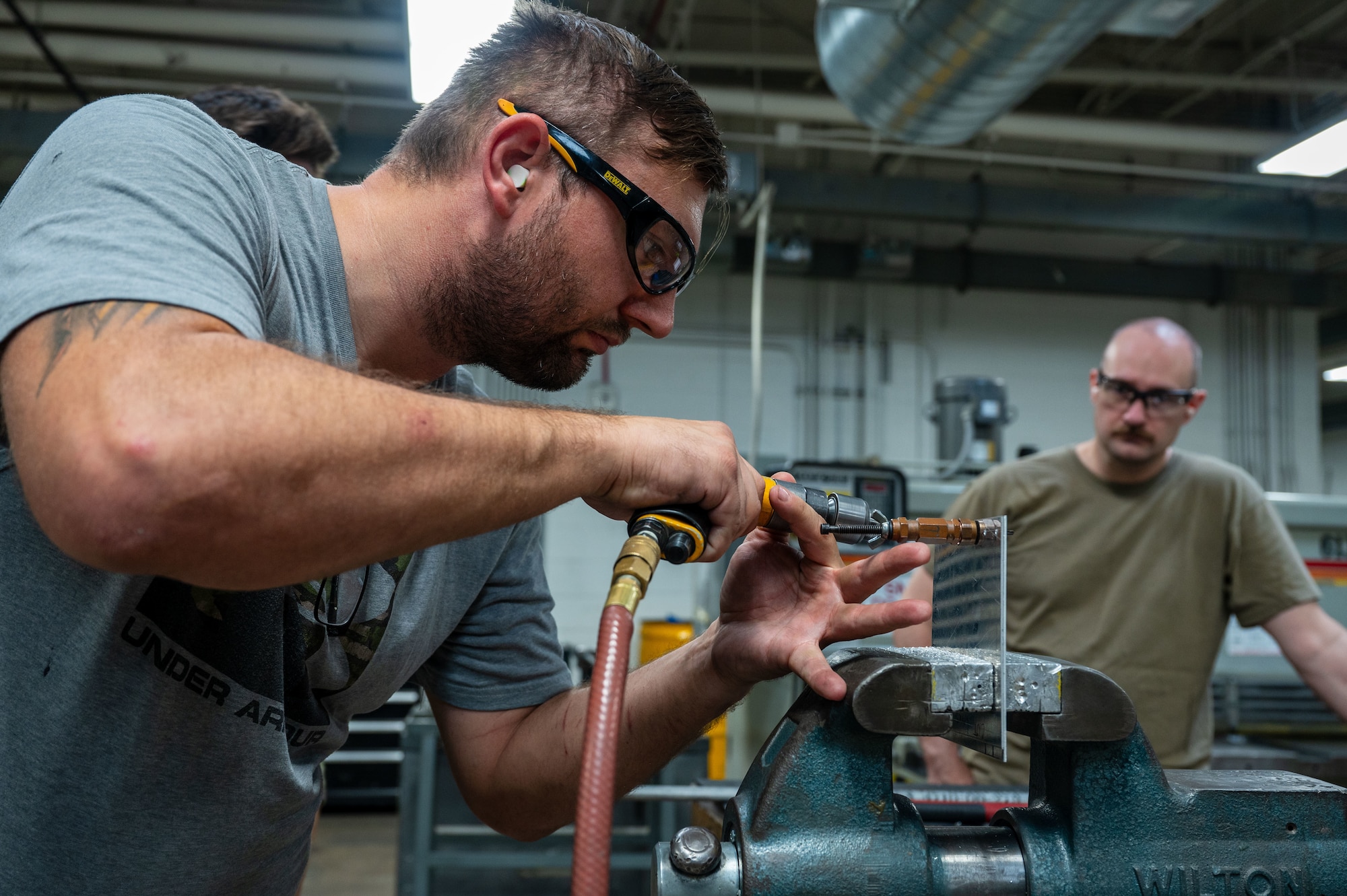 A U.S. Airman assigned to the 355th Aircraft
Maintenance Squadron drills sheet metal
during a Federal Aviation Administration
Airframe and Powerplant certification course
at Davis-Monthan Air Force Base, Ariz., July
17, 2024. The two-week course provided
students with a certification that enhances
their technical proficiency. (U.S. Air Force
photo by Airman 1st Class