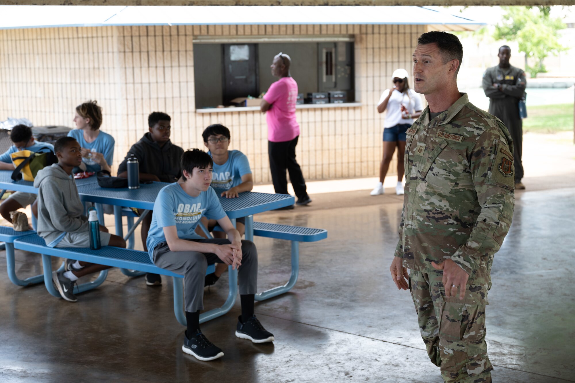 Airman speaks to students during a tour.