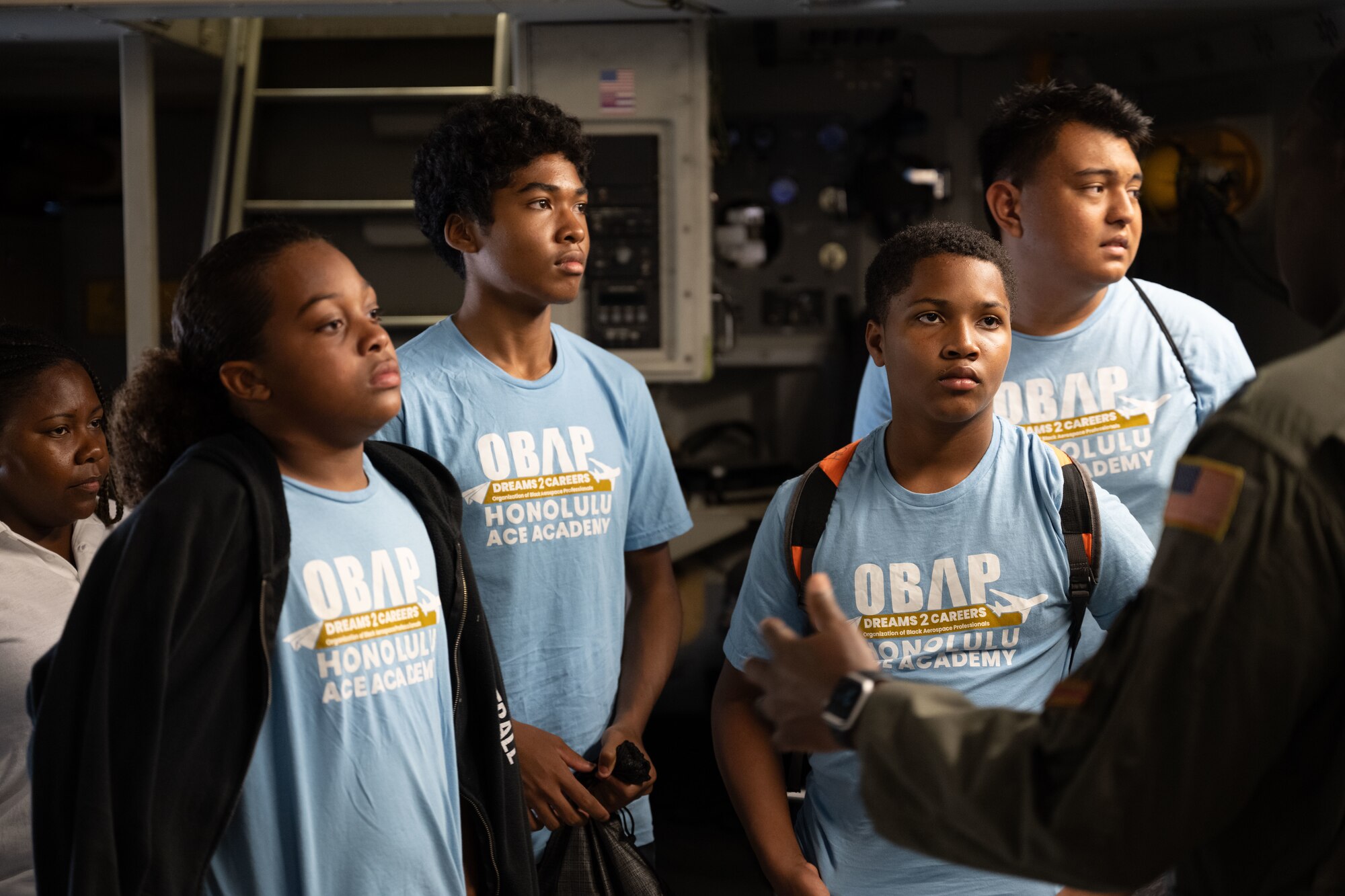 Students listen to an Airman speak.