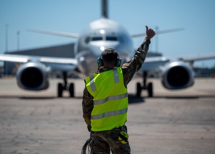 U.S. Air Force Staff Sgt. Ian Mclain, 2 Squadron E-7A Wedgetail Avionics technician, marshals an aircraft for a flight at Royal Australian Air Force Base Darwin, Australia, July 17, 2024.