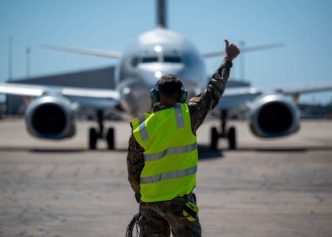 U.S. Air Force Staff Sgt. Ian Mclain, 2 Squadron E-7A Wedgetail Avionics technician, marshals an aircraft for a flight at Royal Australian Air Force Base Darwin, Australia, July 17, 2024.