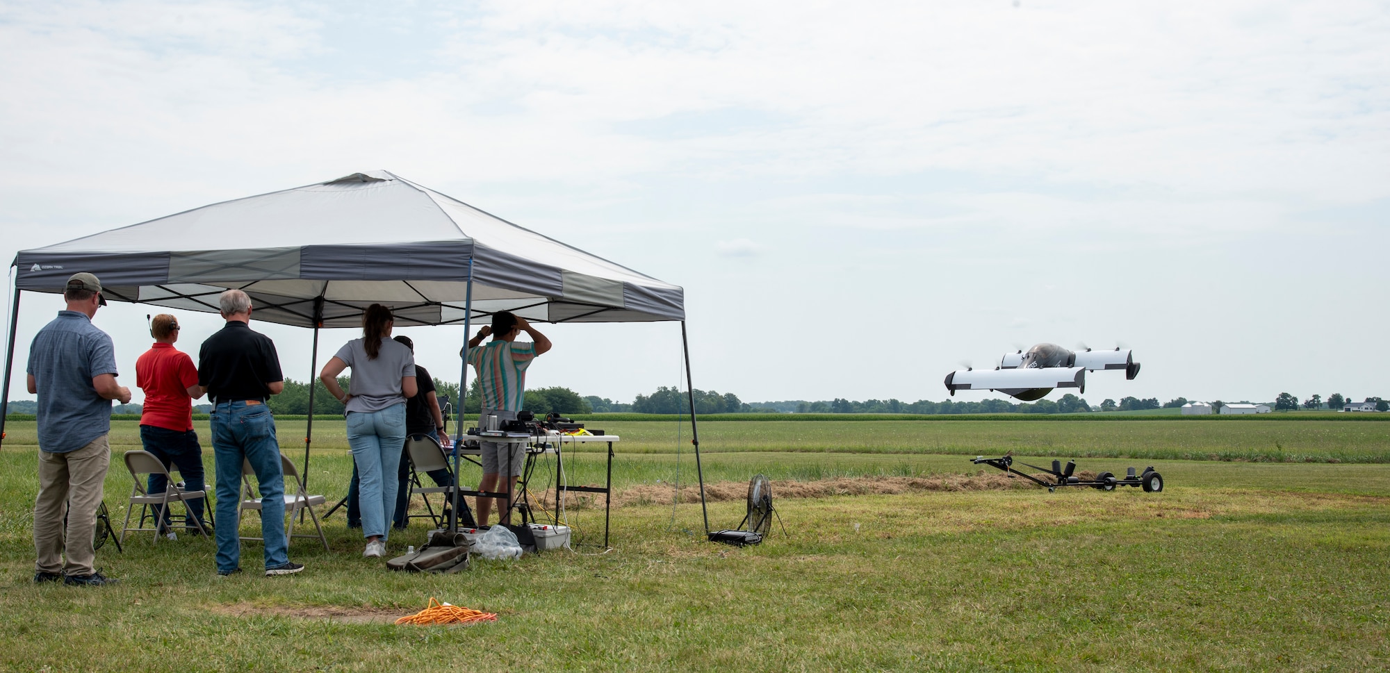 Experts from AFWERX, the Department of the Air Force’s innovation arm within the Air Force Research Laboratory, and Beavercreek, Ohio-based defense contractor Modern Technology Solutions Inc. observe a Pivotal BlackFly electric vertical take-off and landing aircraft test flight at Springfield-Beckley Airport, Ohio, July 12, 2024.