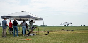 Experts from AFWERX, the Department of the Air Force’s innovation arm within the Air Force Research Laboratory, and Beavercreek, Ohio-based defense contractor Modern Technology Solutions Inc. observe a Pivotal BlackFly electric vertical take-off and landing aircraft test flight at Springfield-Beckley Airport, Ohio, July 12, 2024.