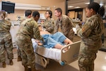 People in military uniforms simulate patient care in a hospital emergency room a medical emergency exercise.