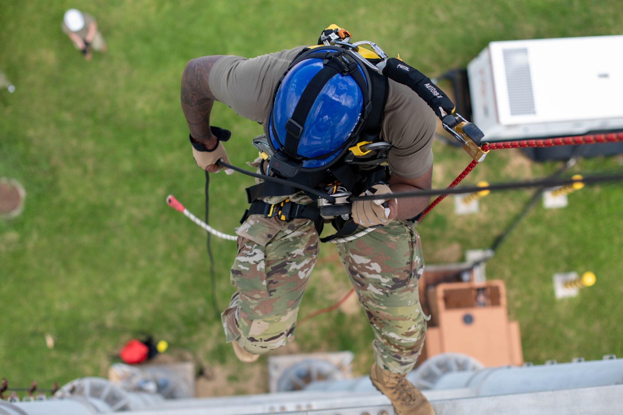 military member rapells down tower